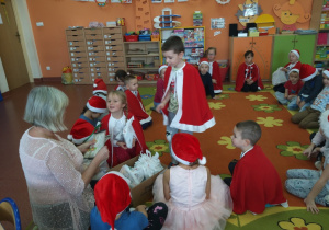 Dzieci z grupy ,,Wiewiórki odbierają prezenty pozostawione przez Świętego Mikołaja