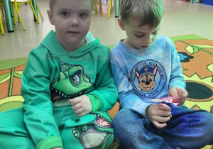 Chłopcy z użyciem latarki zgadują, jaki bajkowy bohater ukrył się za drzwiami zamku.