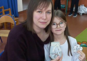 Dziewczynka razem z mamą prezentuje wykonany lampion.