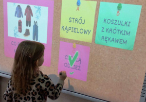 Dziewczynka wskazuje odpowiedź na pytanie.