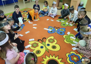 Przedszkolaki dobierają koty do pary.