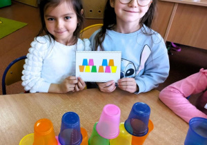 Dziewczynki prezentują kubeczkowe zadanie