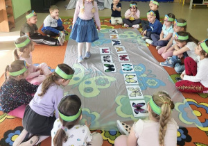 Dziewczynka przelicza sylwety motyli.