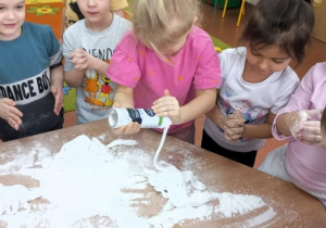 Dzieci wykinują śniegowe chmurki z pianki do golenia.