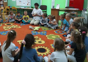 dzieci słuchają opowieści o pracy archeologa
